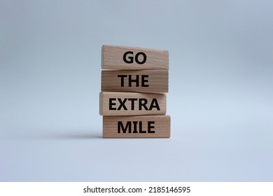 Go The Extra Mile Symbol. Wooden Blocks With Words Go The Extra Mile. Beautiful White Background. Business And Go The Extra Mile Concept. Copy Space.