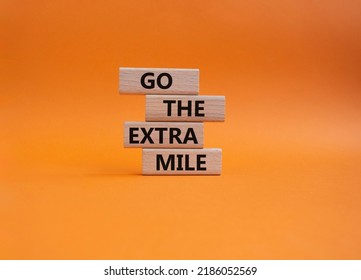 Go The Extra Mile Symbol. Wooden Blocks With Words Go The Extra Mile. Beautiful Orange Background. Business And Go The Extra Mile Concept. Copy Space.