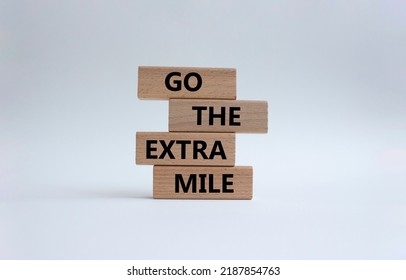 Go The Extra Mile Symbol. Wooden Blocks With Words Go The Extra Mile. Beautiful White Background. Business And Go The Extra Mile Concept. Copy Space.