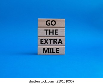 Go The Extra Mile Symbol. Wooden Blocks With Words Go The Extra Mile. Beautiful Blue Background. Business And Go The Extra Mile Concept. Copy Space.