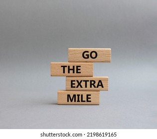 Go The Extra Mile Symbol. Wooden Blocks With Words Go The Extra Mile. Beautiful Grey Background. Business And Go The Extra Mile Concept. Copy Space.