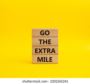 Go The Extra Mile Symbol. Wooden Blocks With Words Go The Extra Mile. Beautiful Yellow Background. Business And Go The Extra Mile Concept. Copy Space.