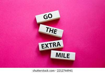 Go The Extra Mile Symbol. Wooden Blocks With Words Go The Extra Mile. Beautiful Red Background. Business And Go The Extra Mile Concept. Copy Space.