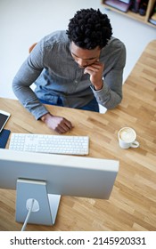 Go Getter In Action. High Angle Shot Of A Young Male Designer At His Desk.