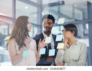 Go getters get things done. Shot of a team of professionals having a brainstorming session at work.