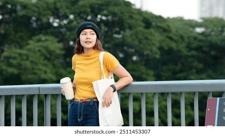 Go green Gen Z woman asia young people looking away in city life nature tree public park reuse cup eco tote bag save the earth world care reduce issues asian future hope net zero waste the way forward - Powered by Shutterstock