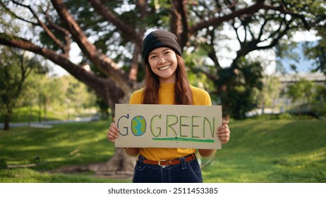 Go green Gen Z woman asia young people smile looking at camera showing save the earth planet world care banner poster sign in city nature tree public park. Protect future asian hope net zero waste. - Powered by Shutterstock