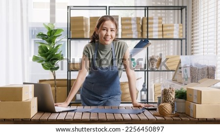 Go green vendor use eco packaging parcel carton box in net zero waste store asian seller retail home office shop. Small SME owner young adult woman asia Gen Z people happy smile pride look at camera.