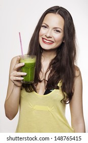 Go Green. Young Beautiful Woman Enjoying A Healthy Raw Fruit Vegetable Juice. Studio Shot.