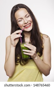 Go Green. Young Beautiful Woman Enjoying A Healthy Raw Fruit Vegetable Juice. Studio Shot.