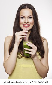 Go Green. Young Beautiful Woman Enjoying A Healthy Raw Fruit Vegetable Juice. Studio Shot.