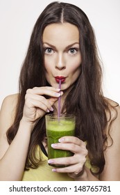 Go Green. Young Beautiful Woman Enjoying A Healthy Raw Fruit Vegetable Juice. Studio Shot.