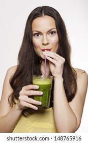 Go Green. Young Beautiful Woman Enjoying A Healthy Raw Fruit Vegetable Juice. Studio Shot.