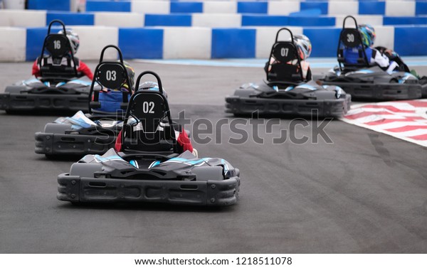 Go Kart racers riding on\
race track