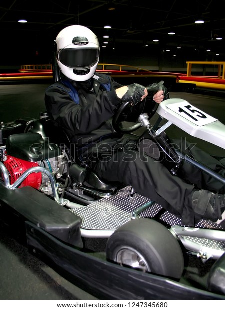 Go kart speed river indoor race opposition race.\
close up racer