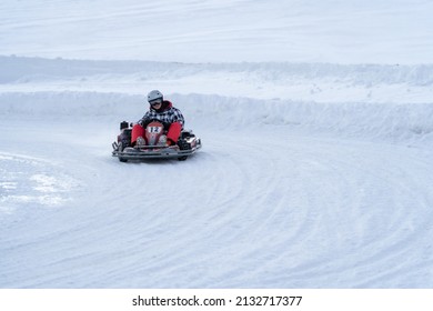 Go Karting On Icy Track In Winter. Adult Kartng Driver In Action On Outdoor Icy Track Covered With Snow