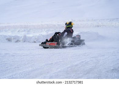 Go Karting On Icy Track In Winter. Adult Kartng Driver In Action On Outdoor Icy Track Covered With Snow