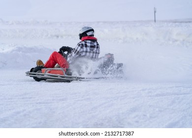 Go Karting On Icy Track In Winter. Adult Kartng Driver In Action On Outdoor Icy Track Covered With Snow