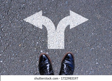 Go left or right. a man standing on the road thinking about choices, turning point, future
