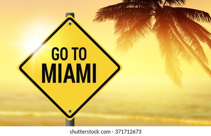 Go To Miami Sign With Blurry Sunset Beach Background