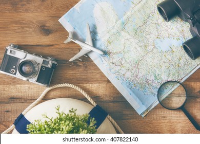 Go on an adventure! The map and the camera on a wooden table. Top view. - Shutterstock ID 407822140