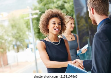 Go outside and meet new people. Shot of a businesswoman and businessman shaking hands outdoors.