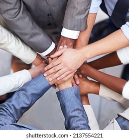 Go, go power business. Cropped shot of a group of businesspeople standing in a huddle with their hands piled up. - Shutterstock ID 2137554221