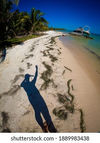 Go Pro Image Of Shadow Of Waving Person On Abandoned Empty Beach And Wreck Boat. 