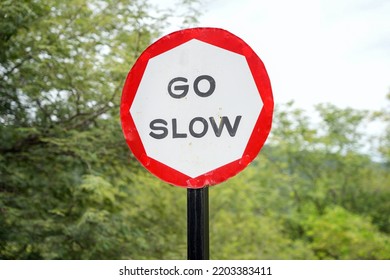 Go Slow Sign Board On The Road