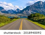 Go To The Sun Road - A Spring evening view of an east section of Go To The Sun Road at Saint Mary Lake, with rugged high peaks towering in the background. Glacier National Park. Montana, USA. 