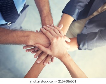 Go Team. High Angle Shot Of A Business Team Putting Their Hands In A Huddle.