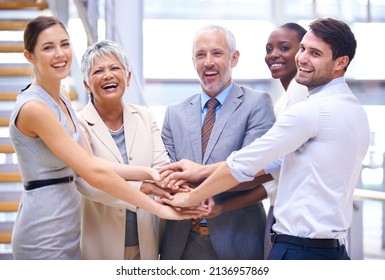 Go Team. Shot Of A Group Of Smilingcoworkers With Their Hands Stacked.