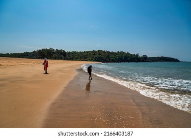 GOA, INDIA - FEBRUARY 23, 202: Unidentified tourists or people walking, running, and enjoying at Galgibaga Beach, South Goa. Galgibaga Beach is one of the best beaches in Goa