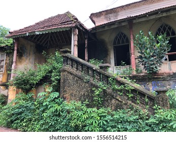 Goa, India - November 10, 2019: Nature Steadily Encroaches On A Dilapidated Portuguese-style House With Terracotta Tiles In North Goa District.