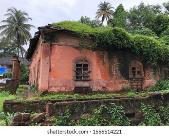 Goa, India - November 10, 2019: Nature Steadily Encroaches On A Dilapidated Portuguese-style House With Terracotta Tiles In North Goa District.