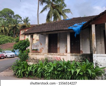 Goa, India - November 10, 2019: Nature Steadily Encroaches On A Dilapidated Portuguese-style House With Terracotta Tiles In North Goa District.