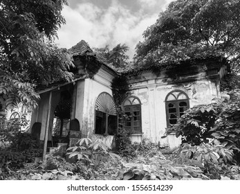 Goa, India - November 10, 2019: Nature Steadily Encroaches On A Dilapidated Portuguese-style House With Terracotta Tiles In North Goa District.