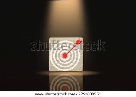 Goal Achievement and objective concept.,Target Dartboard icon Product Showcase or Wooden cubes with spotlight over black background.
