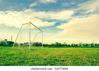 Goal post on grass football playground viewed from ground level with sky.Used color tool for vintage tone. - Shutterstock ID 316772054
