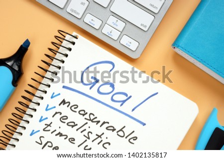 Goal setting concept. Notepad with pen on desk.