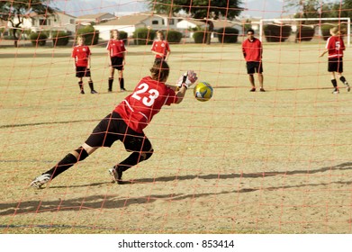 A Goalie Practices For A Girl's Soccer Game.