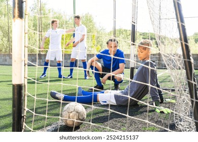 Goalkeeper missed the ball into the goal. Young teen soccer game - Powered by Shutterstock