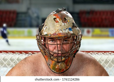 Goalkeeper In An Old Hockey Mask On The Background Of A Hockey Field