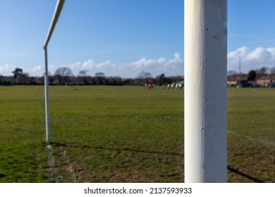 Goalposts On A Sunday League Football Pitch With Narrow Depth Of Field And Players Training In The Background