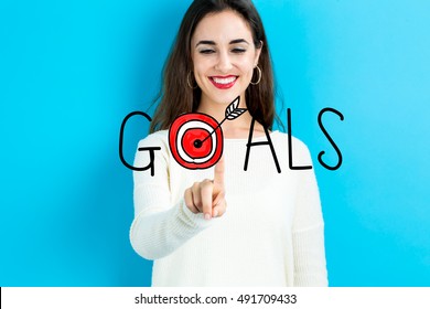 Goals Concept With Young Woman On Blue Background