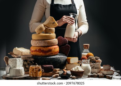 Goat cheese, Different delicious dairy products head of hard cheese in woman's cheesemaker hands,