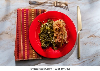 Goat cheese stuffed chicken with sundried tomatoes and side of garlicky broccoli rabe - Shutterstock ID 1955897752