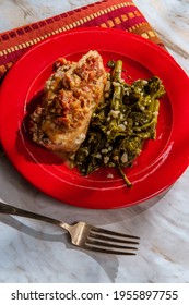 Goat cheese stuffed chicken with sundried tomatoes and side of garlicky broccoli rabe - Shutterstock ID 1955897755