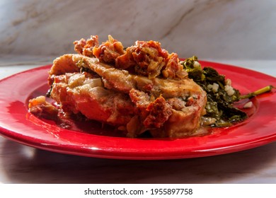 Goat cheese stuffed chicken with sundried tomatoes and side of garlicky broccoli rabe - Shutterstock ID 1955897758