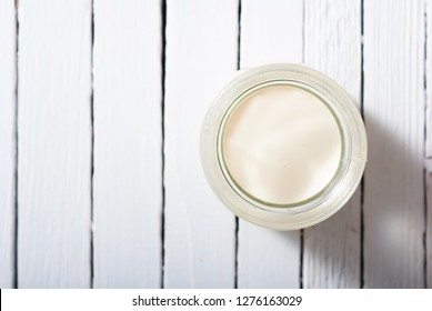 Goat Milk On White Wooden Table